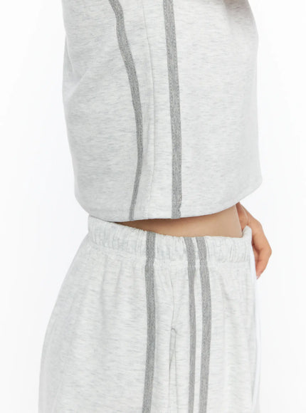 Tank Top and Track Shorts Set CL501 Light gray close-up detail shot of side stripe, showing dual gray stripes running along crop top hem and shorts elastic waistband junction