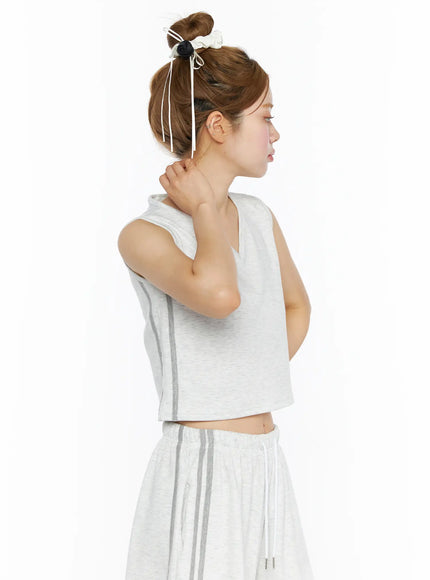 Tank Top and Track Shorts Set CL501 Light gray side model shot, sleeveless crop top with gray side stripe, model hand touching neck, wide culottes shorts below
