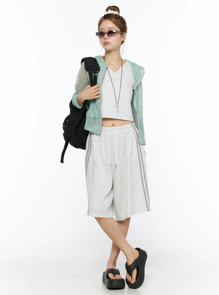 Tank Top and Track Shorts Set CL501 Light gray styled full-length model shot, green mesh jacket layered over crop top, wide-leg shorts, backpack and sunglasses accessories
