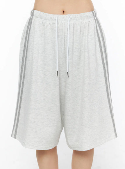 Tank Top and Track Shorts Set CL501 Light gray front close-up model shot of shorts only, wide-leg silhouette, white drawstring, dual gray side stripes, melange cotton texture