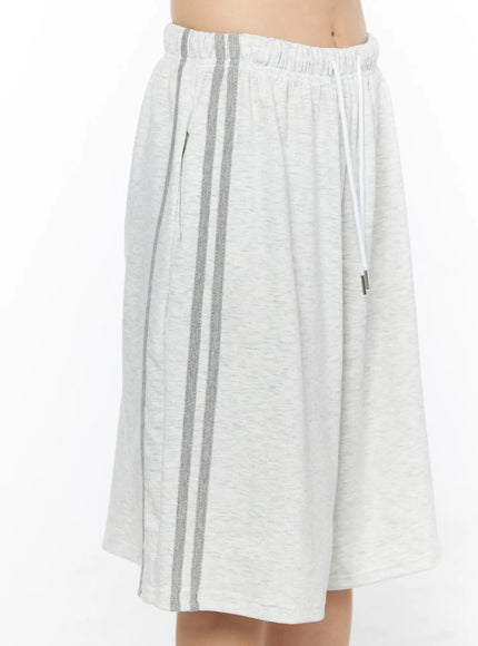 Tank Top and Track Shorts Set CL501 Light gray side close-up model shot of shorts, dual gray side stripes, side pocket detail, elastic waistband with white drawstring visible