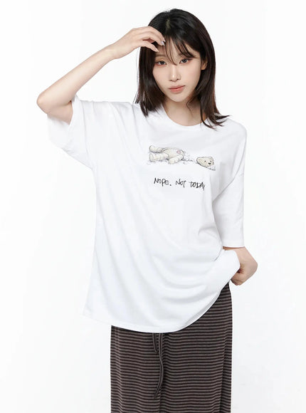 Teddy Graphic Oversize T-Shirt IL506 White front model hand raised to head relaxed pose graphic bear print and boxy oversized cotton silhouette