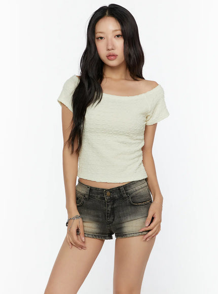 Textured Off-Shoulder Top CU529 Light yellow front view on standing model wearing pendant necklace sunglasses on head and dark denim shorts with black knee-high boots