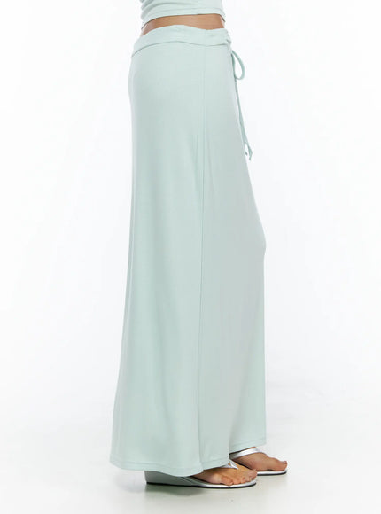 Tie-Waist Maxi Skirt CL503 Mint side shot on model showing silhouette of low-rise drawstring waistband and floor-length flared hem
