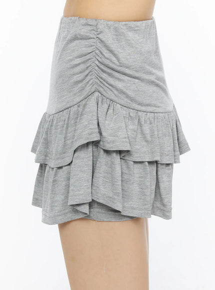Tiered Flare Mini Skirt CU530 Gray side shot on model showing center-front ruched detail and two-tier flared hem in heathered jersey fabric