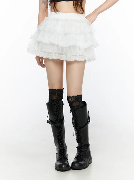 Tiered Mesh Mini Skirt CL522 White front shot on model showing multi-tier ruffled organza mini skirt with elastic waistband paired with black lace-up knee boots