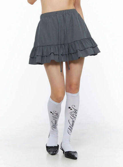 Tiered Ruffle Mini Skirt CL501 Dark gray front close-up on model showing double-tiered ruffle hem elastic waist and drawstring detail
