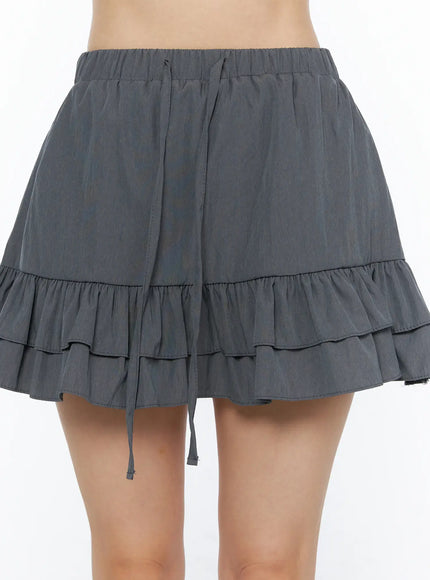 Tiered Ruffle Mini Skirt CL501 Dark gray close-up front detail shot showing elastic waistband drawstring tie double ruffle hem and fabric texture