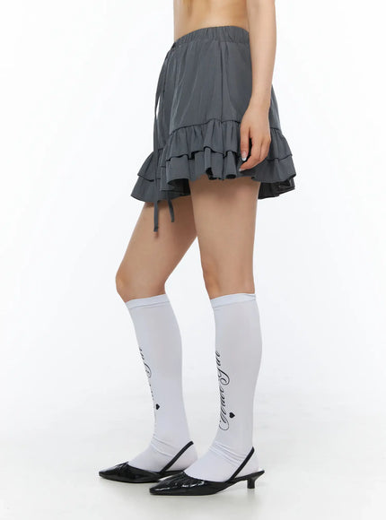 Tiered Ruffle Mini Skirt CL501 Dark gray side shot on model revealing tiered ruffle layers lightweight fabric and side drawstring tie