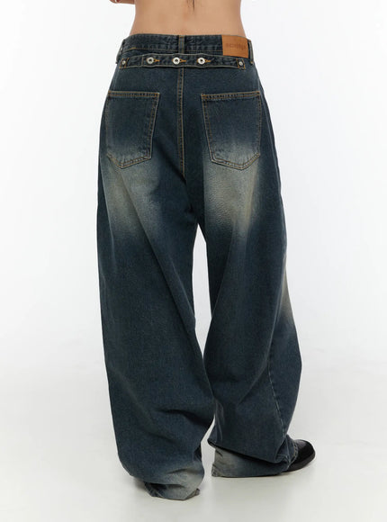 Tuli Back-Belt Detail Baggy Jeans CU529 Dark blue back shot on model showing dual back pockets snap-button belt strap leather patch label and faded wash