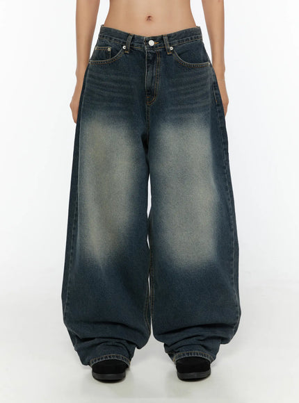 Tuli Back-Belt Detail Baggy Jeans CU529 Dark blue front close-up shot on model showing waistband front pockets white button and vintage wash fading