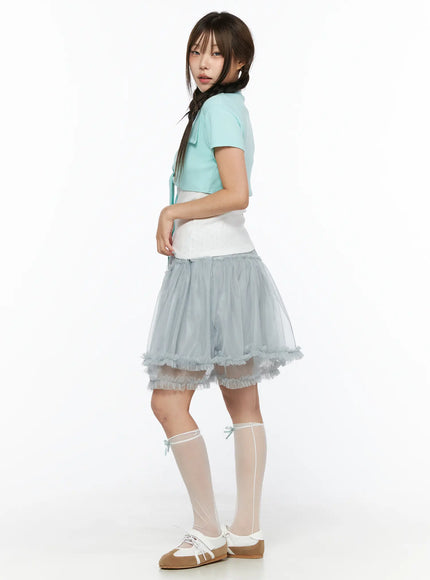 Tulle Frill Hem Midi Skirt CL514 Light blue side shot on model standing with braid pigtails, sheer tiered tulle silhouette and ruffled hem visible from side angle