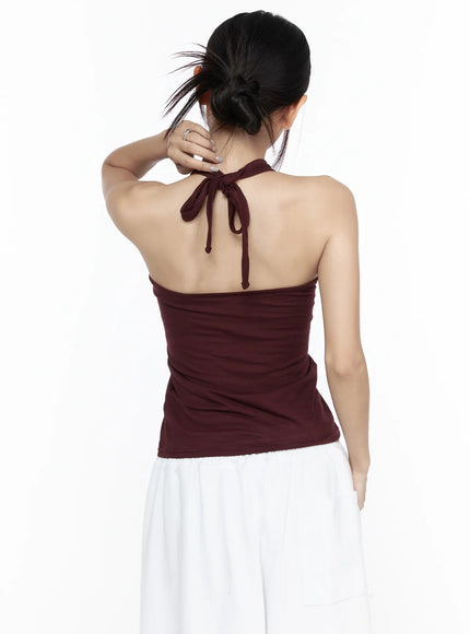 Twist Halter Top CL524 Dark red close-up back detail on model highlighting neck tie bow knot and ribbed texture across open bare back