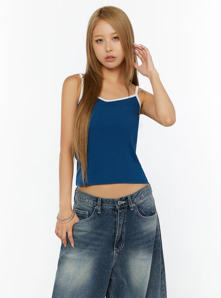 Two-Tone Cami Top IL524 Blue front model half-body shot model touching hair hand raised cropped ribbed knit with white contrast strap and neckline detail