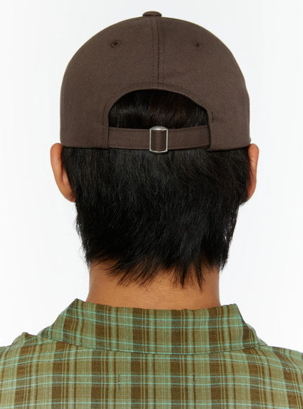 Two-Tone Graphic Cap IL515 Dark brown back model shot, model facing away showing all-brown back panel with silver slide buckle adjuster strap