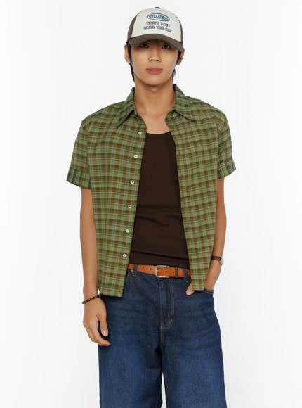 Two-Tone Graphic Cap IL515 Dark brown front model shot, male model standing straight facing camera wearing cap with green plaid open shirt over brown tank