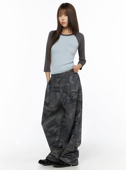 Two-Tone Long Sleeve Top IL523 Light blue side-angle full-body shot on model with hands clasped, cropped hem visible over camo sweatpants