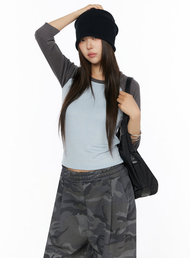 LEWKIN Two-Tone Long Sleeve Top IL523 Light blue front shot on model wearing black bucket hat and camo pants with shoulder bag, cropped fit