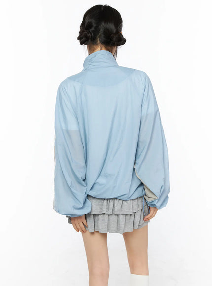 Two-Tone Oversized Windbreaker CU530 Light blue back shot on model showing oversized silhouette high stand collar and dropped shoulder lightweight nylon fabric