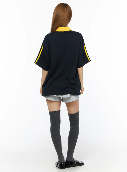Two-Tone Relaxed-Fit Polo Shirt CL502 Dark blue back shot on model showing yellow collar contrast yellow double sleeve stripes and clean oversized back hem with grey shorts
