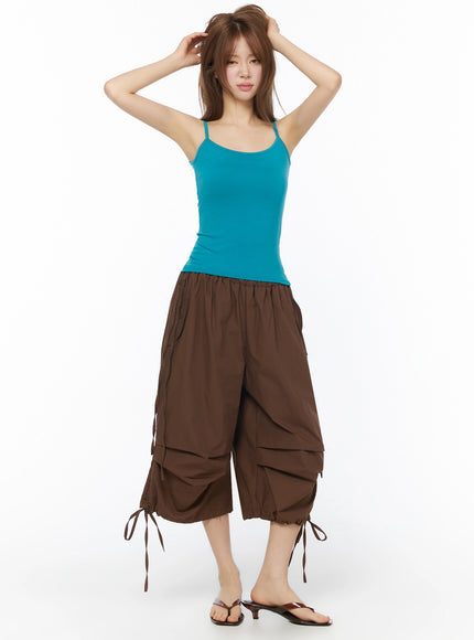Two-Way Layered Cami Top IU525 Blue full-length front shot on model arms raised styled with brown cargo cropped pants and thong sandals