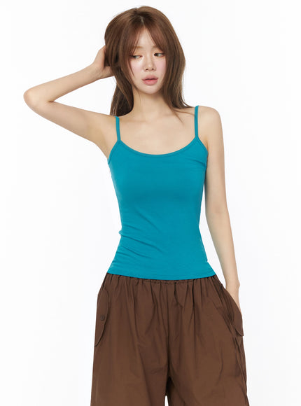 Two-Way Layered Cami Top IU525 Blue front half-body shot on model hand touching hair showing fitted torso and scoop neckline detail