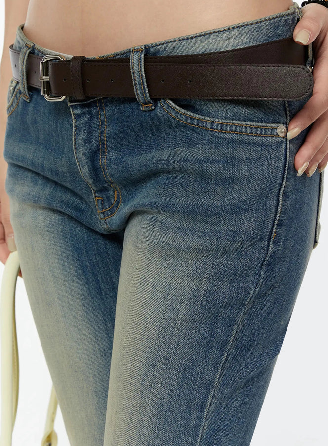 Unisex Square Belt IU524 Brown side-angle close-up on model with belt tail extended over low-rise cropped denim, silver buckle and smooth leather texture visible