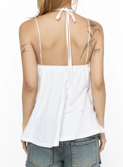 V-Neck Halter Flared Sleeveless Top CL528 White back close-up on model showing open back design, tied halter neck knot, double thin straps and flared cotton hem