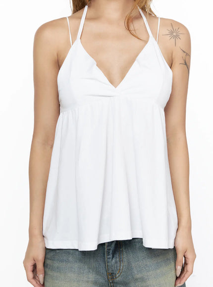 V-Neck Halter Flared Sleeveless Top CL528 White close-up front detail on model showing deep V-neckline, empire waist gather, thin halter straps and flared hem