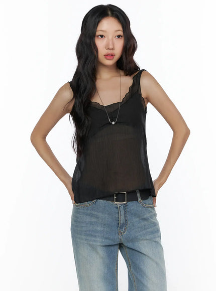 V-Neck Layered Sleeveless Blouse CL510 Black front shot on model hands on hips with scalloped V-neckline sheer chiffon fabric silver necklace and blue jeans with belt