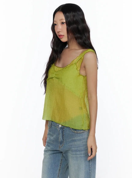 V-Neck Layered Sleeveless Blouse CL510 Green side shot on model cropped view showing scalloped strap and sheer chiffon drape paired with blue wide-leg jeans