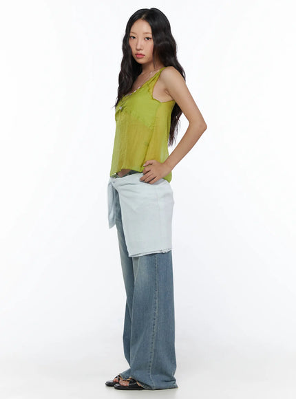 V-Neck Layered Sleeveless Blouse CL510 Green side shot on model full-body pose with hand on hip styled over jeans and white shirt tied at waist sheer silhouette