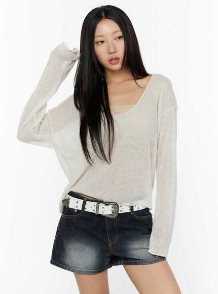 V-Neck Lightweuight Knit Top CU526 Cream front view on model with hand raised, scoop neckline, sheer lightweight knit, layered over beige cami