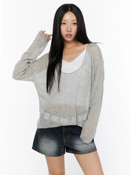 V-Neck Lightweuight Knit Top CU526 Light Gray front view on model with hand touching hair, semi-sheer speckled knit, layered over white cami