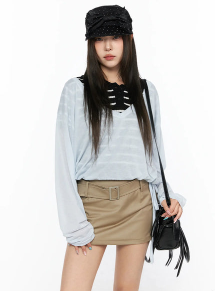 V-Neck Loose Drawstring Long Sleeve Top CL514 light blue front view model wearing studded black cap and crossbody bag styled with khaki mini skirt standing pose