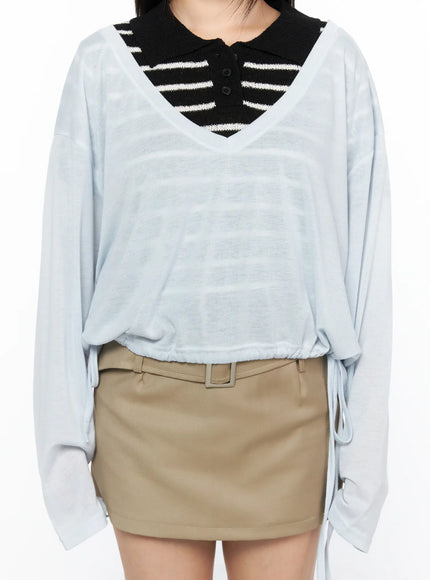 V-Neck Loose Drawstring Long Sleeve Top CL514 light blue close-up front detail showing V-neck sheer fabric striped black inner top and drawstring waist hem on model