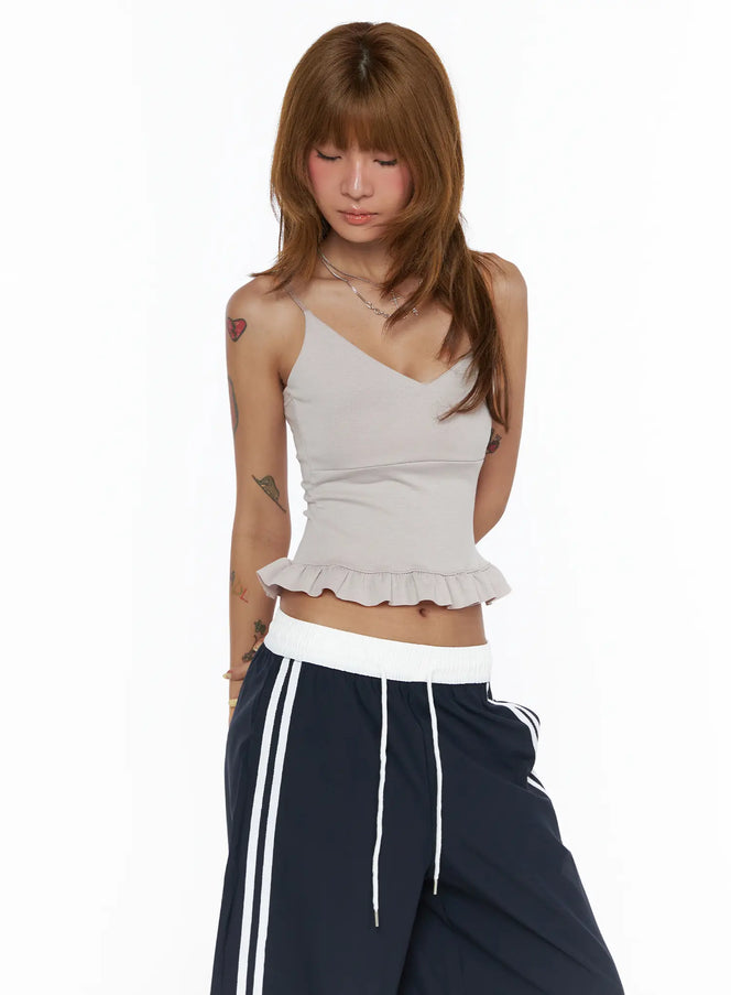 V-Neck Ruffle Cami Top CL503 light gray front shot on model looking down, V-neck spaghetti strap crop top with pleated ruffle hem