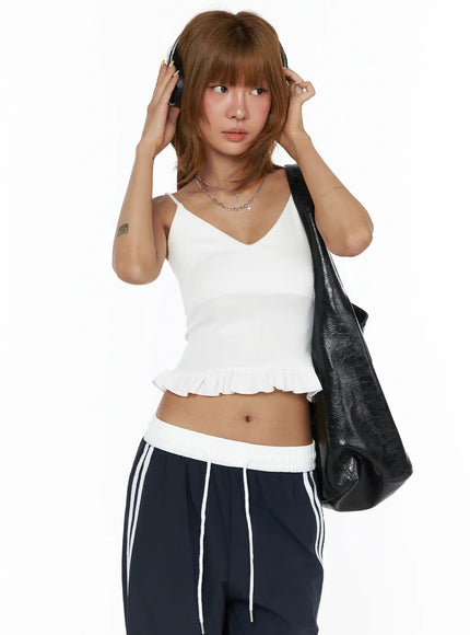 LEWKIN V-Neck Ruffle Cami Top CL503 White S/M front shot on model wearing headphones and black bag, fitted ribbed crop with ruffle hem