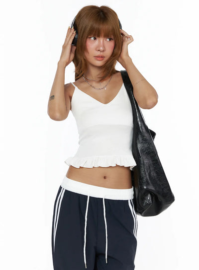 LEWKIN V-Neck Ruffle Cami Top CL503 White S/M front shot on model wearing headphones and black bag, fitted ribbed crop with ruffle hem