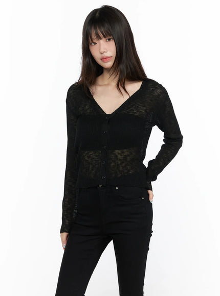 V-Neck Sheer Cardigan CL522 black front shot on model, semi-sheer ribbed knit with V-neck and button placket, layered over camisole, paired with black pants