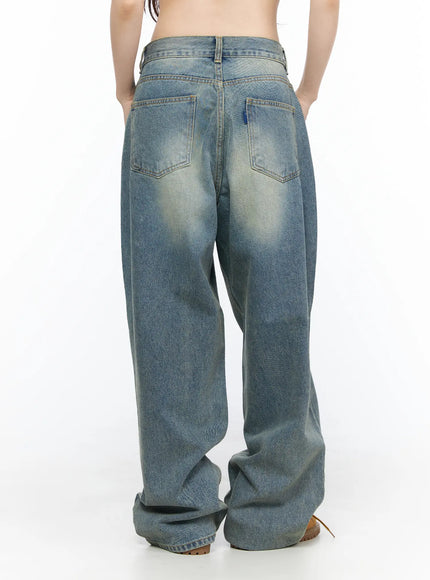 Vexi Washed Baggy Jeans CL523 Blue back close-up on model showing dual rear pockets with contrast stitching, waistband, and vintage sand-faded denim texture
