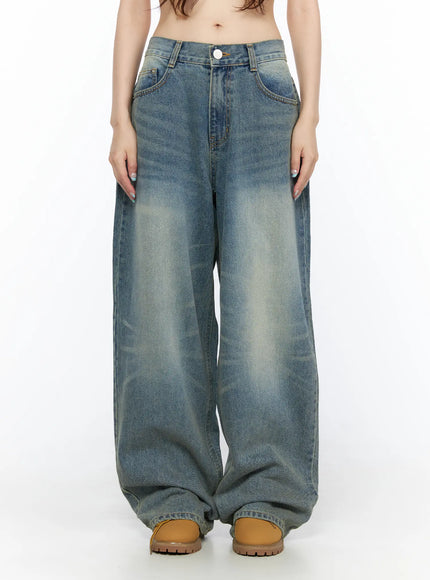 LEWKIN Vexi Washed Baggy Jeans CL523 Blue front close-up on model showing low-rise waistband, button closure, front pockets, and faded wash denim texture, Size S
