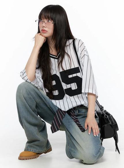 Vexi Washed Baggy Jeans CL523 Blue styled on crouching model in striped jersey and glasses, showing relaxed baggy fit pooling at ankles with streetwear accessories