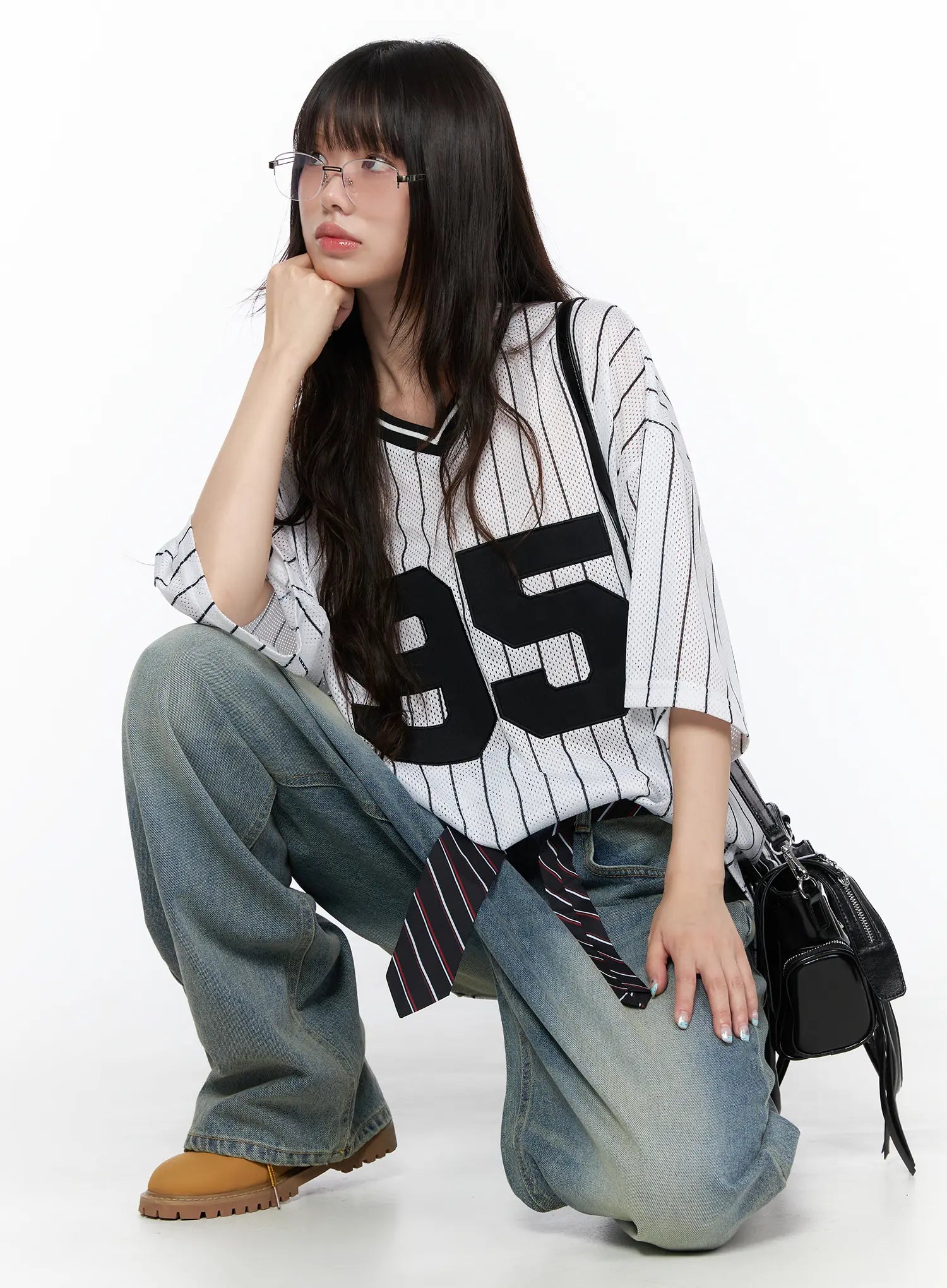 Vexi Washed Baggy Jeans CL523 Blue styled on crouching model in striped jersey and glasses, showing relaxed baggy fit pooling at ankles with streetwear accessories