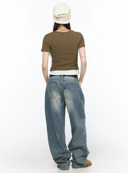 Vexi Washed Baggy Jeans CL523 Blue full-body back shot on model in white beanie and olive crop top, showing rear pockets and wide-leg denim draped over tan boots