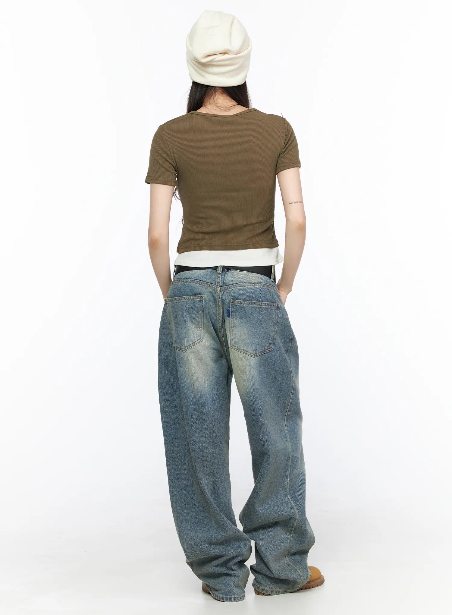 Vexi Washed Baggy Jeans CL523 Blue full-body back shot on model in white beanie and olive crop top, showing rear pockets and wide-leg denim draped over tan boots