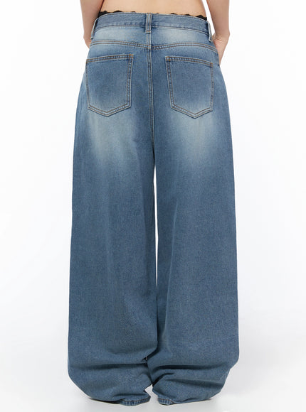 Veya Washed Baggy Jeans IU525 Blue back waist close-up shot on model showing dual back pockets, contrast stitching, center seam, and black lace trim detail