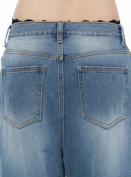Veya Washed Baggy Jeans IU525 Blue close-up back detail shot showing two patch pockets with orange topstitching, faded wash texture, and black lace waistband trim