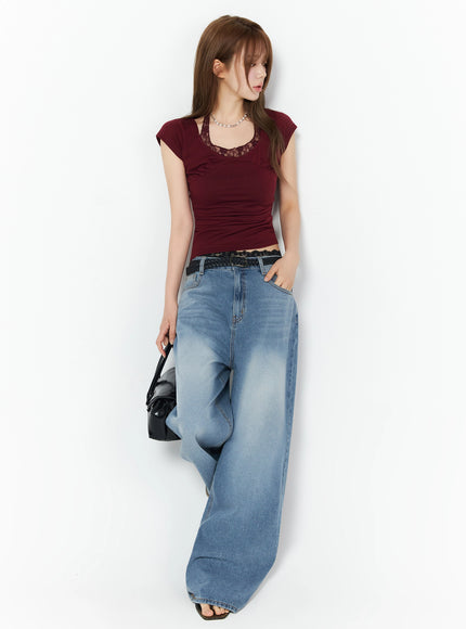 Veya Washed Baggy Jeans IU525 Blue full-length side-angle shot on model styled with burgundy lace crop top, black belt, and black bag, wide-leg silhouette