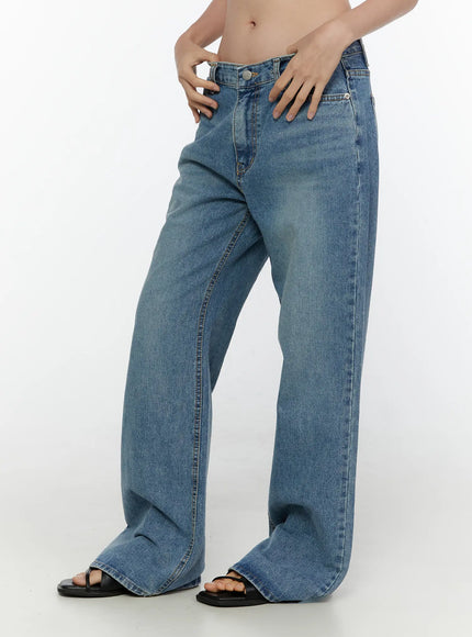Vienne Wide Leg Jeans CL521 Blue side view on model hands resting on hips, low-rise wide-leg cut with washed blue denim texture, black sandals